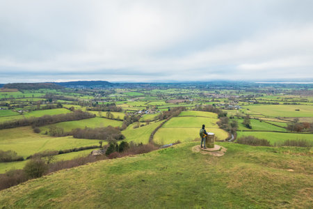 backpacker hiker on the high ground of Coaley Peak, Stroud, Gloucestershire, UK, daytimeの写真素材