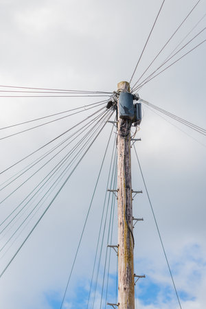 Utility pole with lots of cables connected, England, UKの写真素材