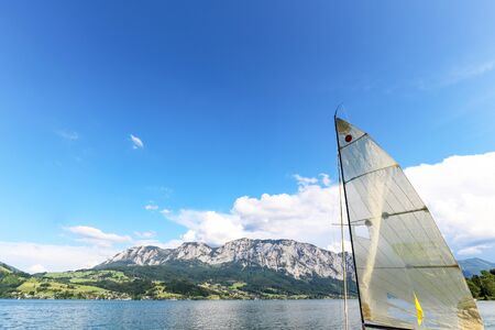 View to lake Attersee with sailing boat, Mountains of austrian alps near Salzburg, Austria Europe