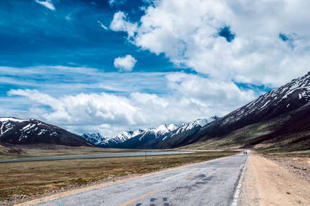 Two people walking on the roadの写真素材