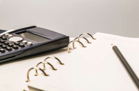 Desktop with files, pencil and calculatorの写真素材