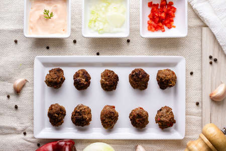 Meatball with sauces on white plate