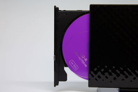 purple cd disk in black drive