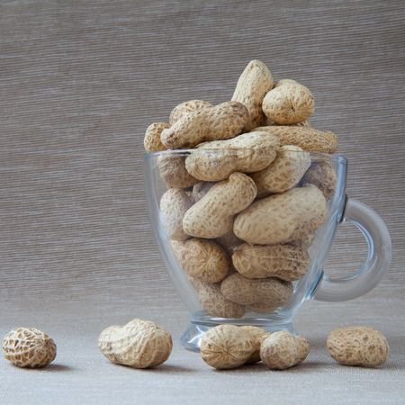 peanuts in a shell in a glass cup
