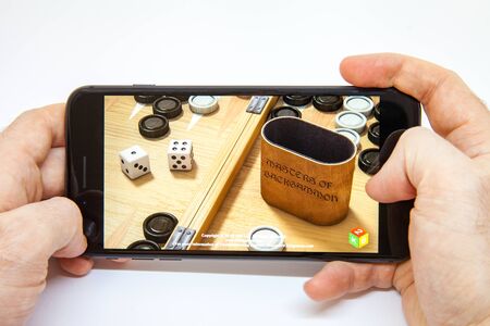 Moscow / Russia - February 19, 2019: smartphone in hand. backgammon game download