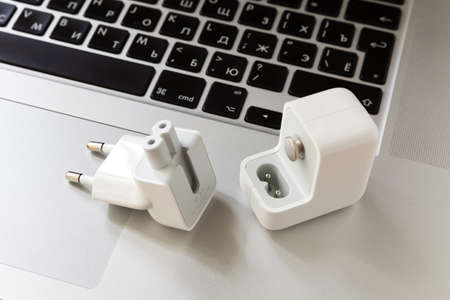 Moscow / Russia - May 11, 2019: White USB 12 watt power adapter on the MacBook keyboardのeditorial素材