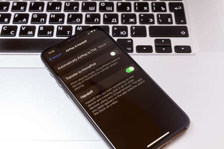 Moscow / Russia - January 18, 2020: Black iPhone 11 Pro lies on a MacBook. Handoff is enabled on screenのeditorial素材