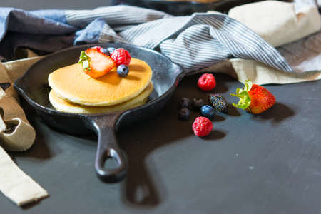 Selective focus Pancakes with blueberries  & raspberry on wood backgroundの写真素材