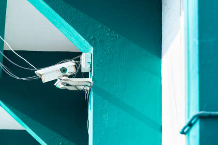 Modern security camera on the indoor concrete wall