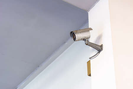 Modern security camera on the indoor concrete wall
