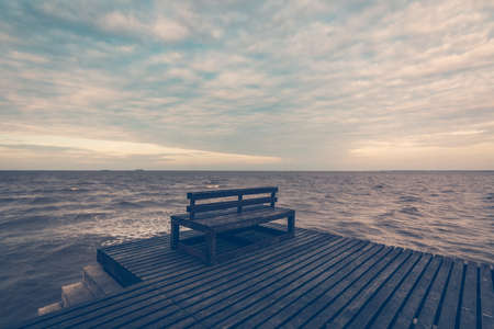 Wooden chair on wooden foot bridgeの写真素材
