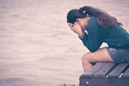 Women sits on a wooden chairの写真素材