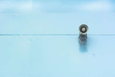 Old loud speaker on the iron wall backgroundの写真素材