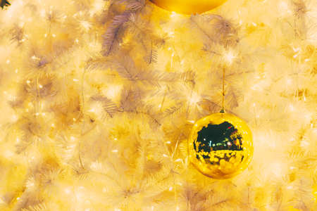 Yellow christmas ornaments on treeの写真素材