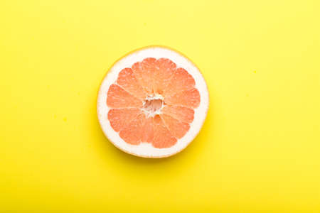 grapefruit with yellow backgroundの写真素材