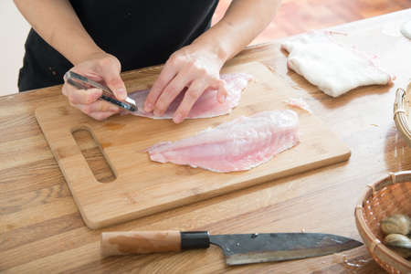 removing fish bone for sashimiの写真素材