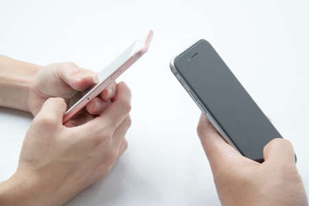close up of hands of couple using smart phone