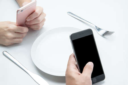 using smart phone while waiting food at restaurant