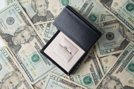diamond ring on money