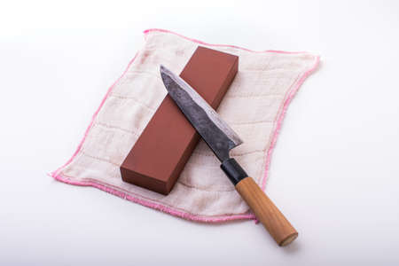 sharpening japanese knife with grindstoneの写真素材