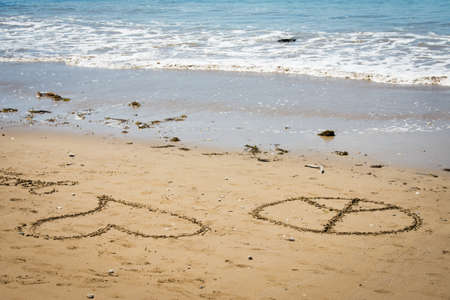 love and peace sign on beachの写真素材