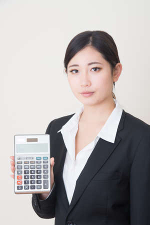 young asian woman with calculatorの写真素材
