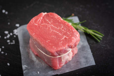 raw fillet mignon with rosemarry, salt and pepperの写真素材
