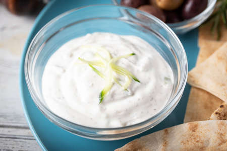 tzatziki with pita bread on blue plate