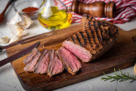 sliced tri tip seak marinated with santa maria sauce  on wooden cutting boardの写真素材