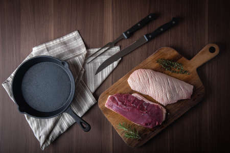 raw duck breast meat on cutting board