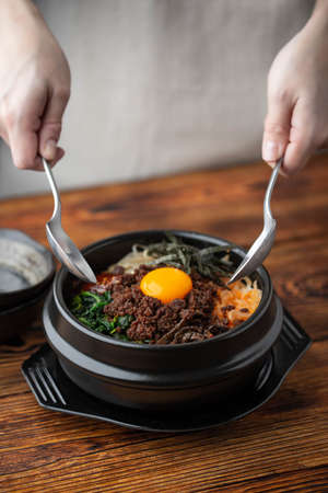 mixing korean famouse hot stone bowl bibimbapの写真素材