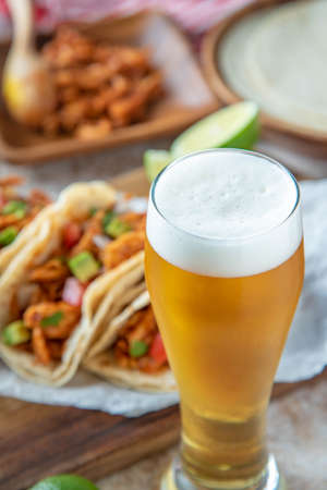 shredded chicken tacos with glass of beerの写真素材