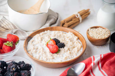 oatmeal with berries in wood bowlの写真素材