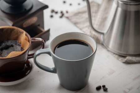 dripping coffee image with mug , paper filter and kettleの写真素材