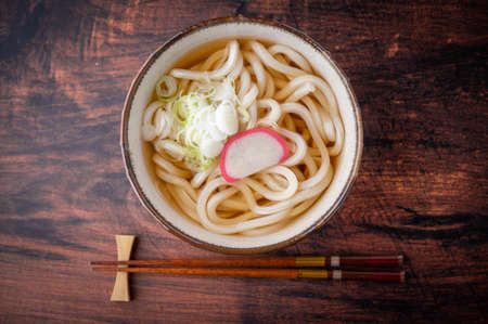 udon noodle soup with green onion and kamabokoの写真素材
