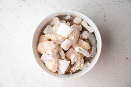 frozen seafood in white bowl