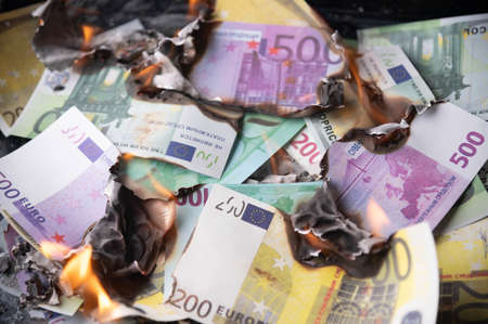 burning euro bills for financial crisis backgroundの写真素材