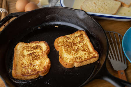 cooking french toast with iron skillet panの写真素材