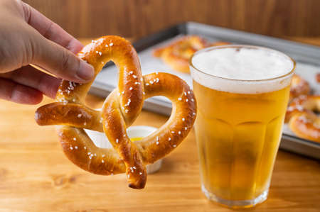 baked pretzel on cooking pan with beerの写真素材