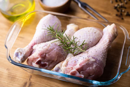 fresh chicken drumsticks on kitchen counter tableの写真素材