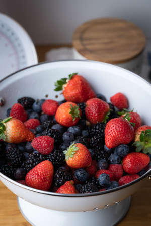 berries in white antique strainerの写真素材