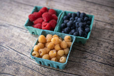 raspberry, yellow raspberry and blueberryの写真素材