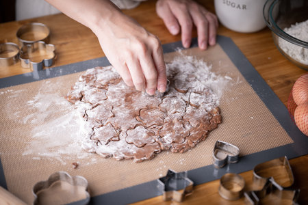 cutting out cookie dough with hands