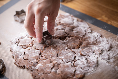 cutting out cookie dough with hands