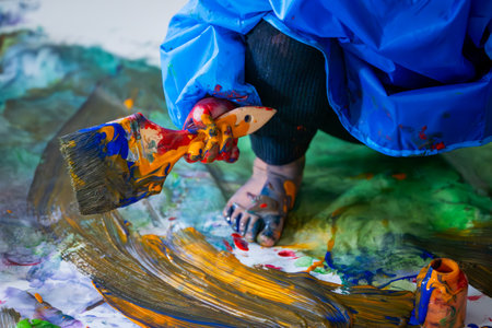 dirty toddler painting on paperの写真素材