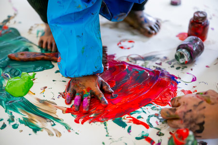 dirty toddler painting on paperの写真素材