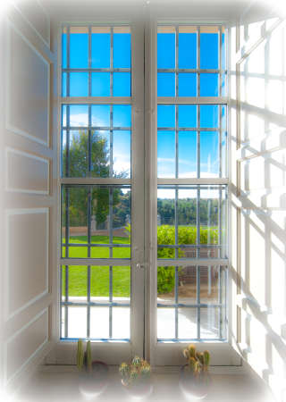 Looking through a window out into the sunny day.の写真素材