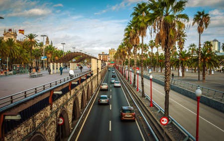 People and traffic in the city streets of coastal Barcelona on a warm autumn afternoon.のeditorial素材