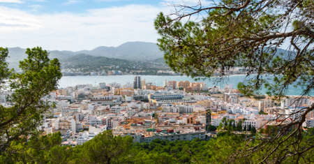 High, hill side view of St Antoni de Portmany & surrounding area in Ibiza.  Clearing November day, kindly warm breeze in autumn,  Balearic Islands, Spain.の写真素材