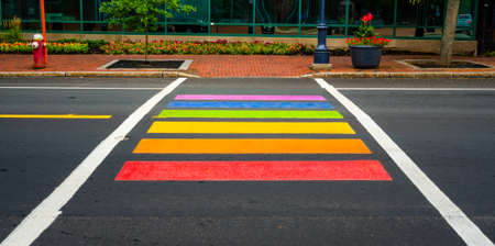Rainbow colored pedestrian crossing in Moncton, New Brunswick.    Bright, colorfully painted pedestrian crossing in city of Moncton New Brunswick, Canada.  All inclusive signal.の写真素材